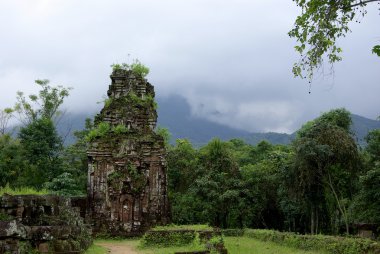 Cham ruins in lush vegetation clipart