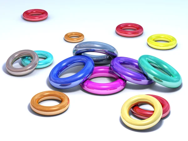 stock image Colored shiny rings on a white floor