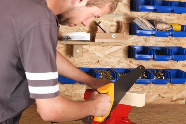 Young carpenter cutting — Stock Photo, Image