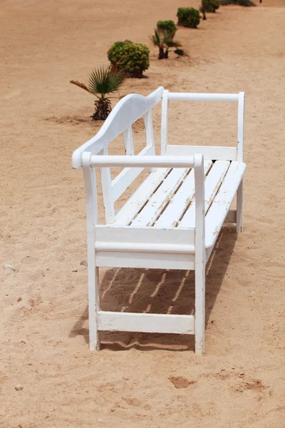 White bench in sand — Stock Photo, Image