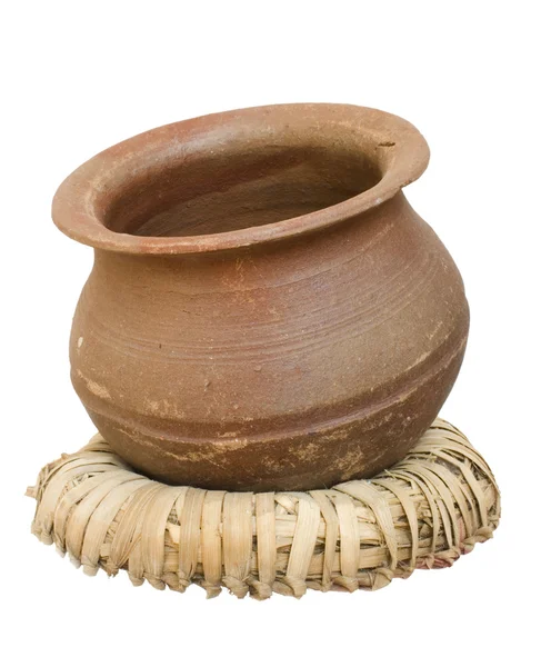 Handmade clay pot on a wicker stand — Stock Photo, Image