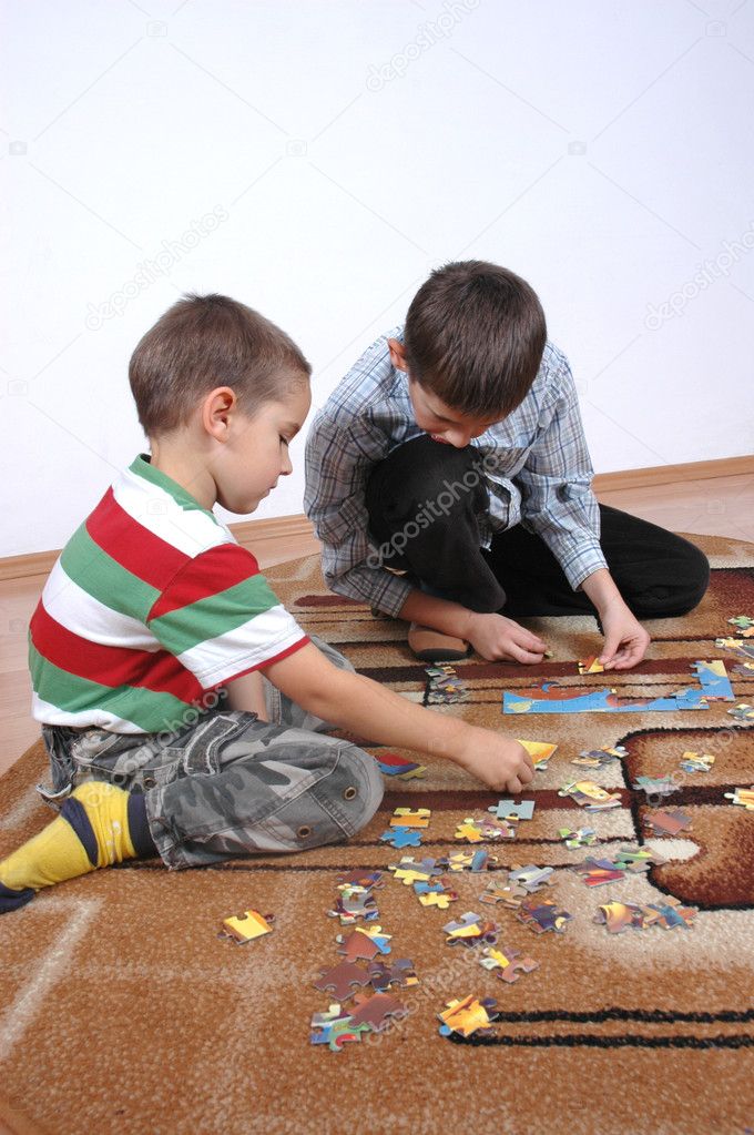 Boys playing the puzzle