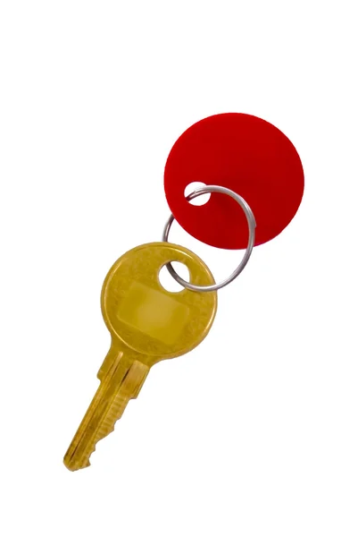 Goldener Schlüssel mit rotem Anhänger — Stockfoto
