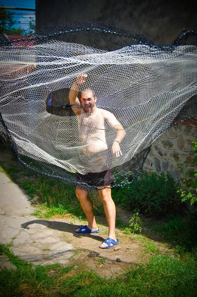 Fisherman throwing net — Stock Photo, Image