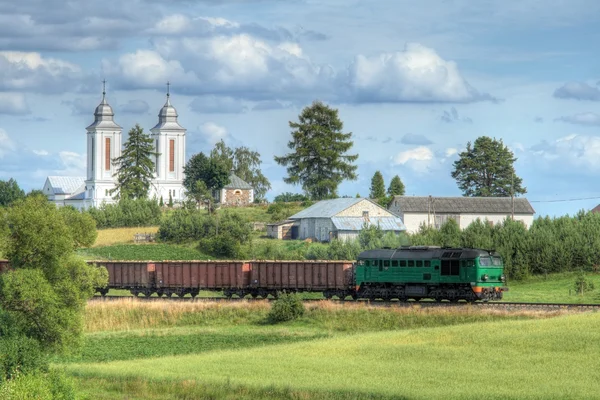 Comboio de carga passando pela aldeia — Fotografia de Stock