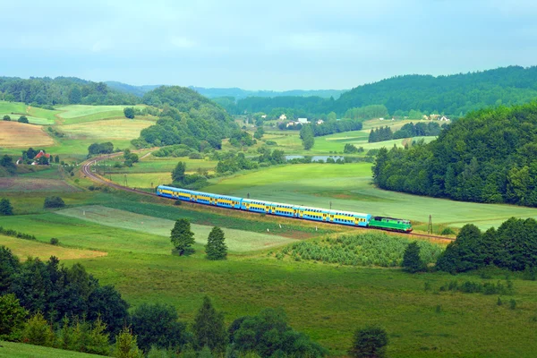 Landscape with a railway line, train, la — Stock Photo, Image