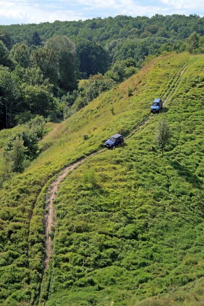 stock image Two cars climbing up the slope