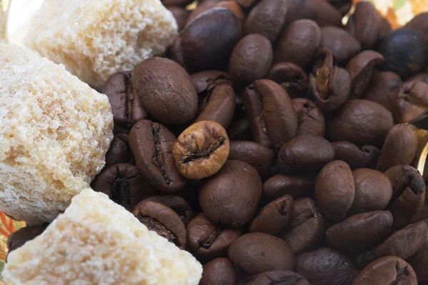Lots of natural coffee beans with sugar — Stock Photo, Image