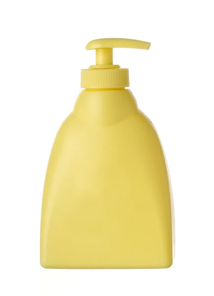 Желтая пластиковая мыльная бутылка — стоковое фото