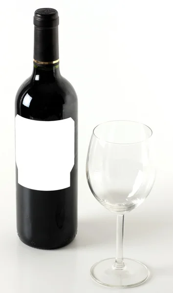Red wine bottle with empty wineglass — Stock Photo, Image