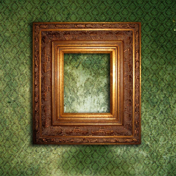 Moldura dourada sobre grunge papel de parede verde — Fotografia de Stock