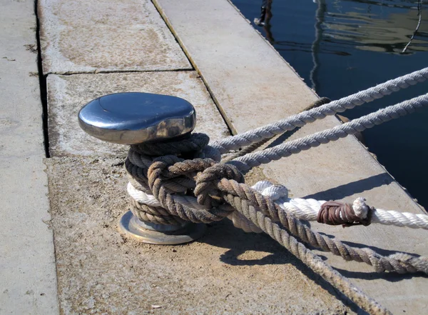 stock image Chrome capstan with white ropes