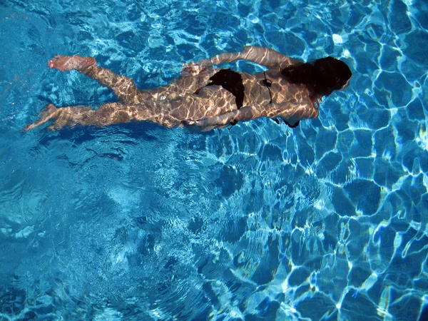 Женщина, плавающая под водой — стоковое фото