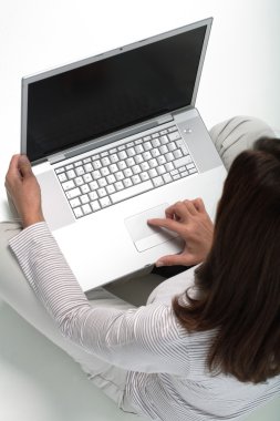 Woman working on a laptop clipart