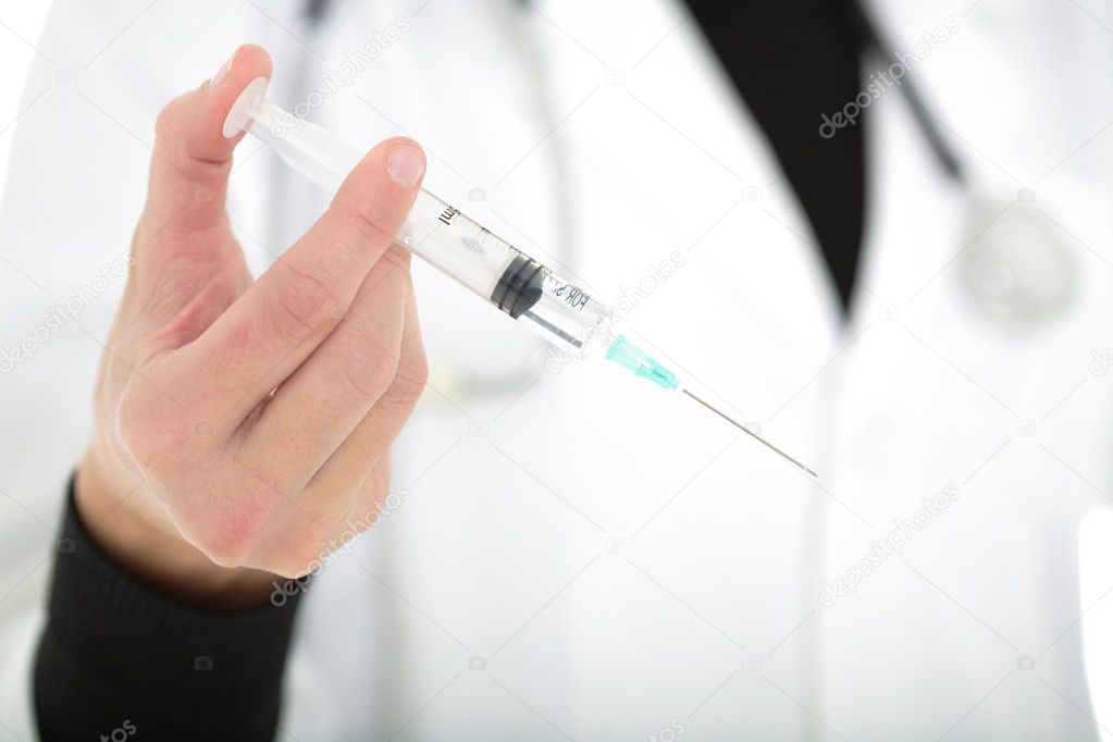 Surgeon holding syringe