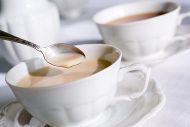 Teaspoon over cup of tea or coffee clipart