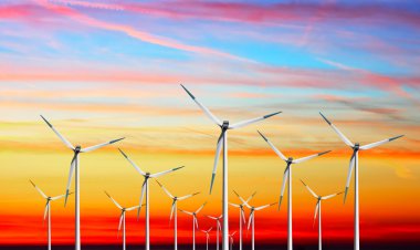 Wind turbines farm on sunset clipart