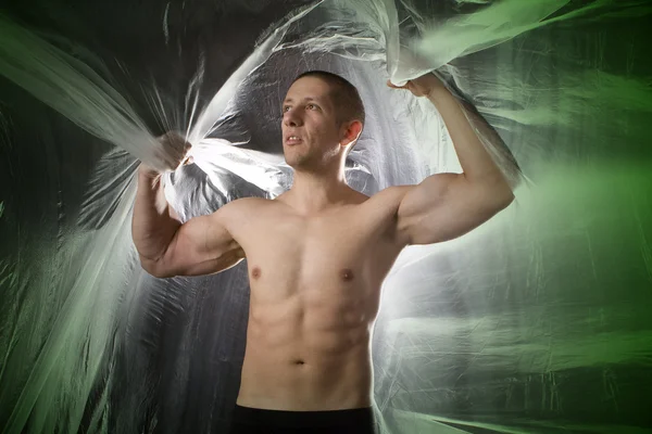 Homem sexy muscular em fundo abstrato — Fotografia de Stock