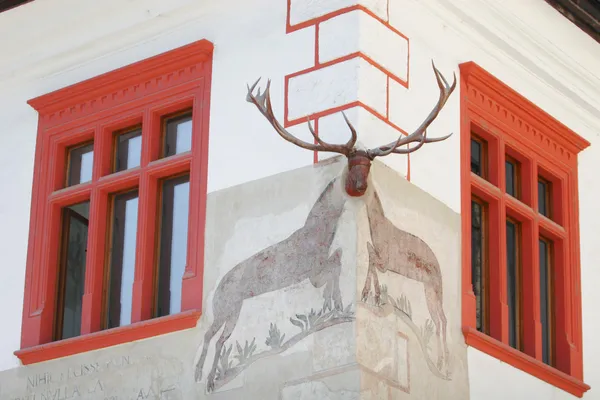 Stock image Two red windows decorated with stag horn