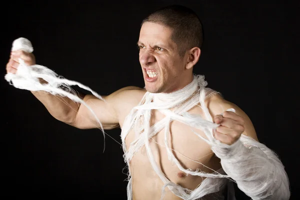 stock image Bandaged young man in studio on black ba