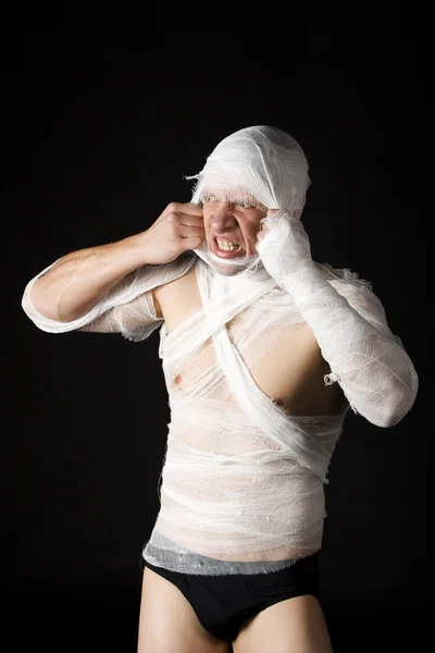 stock image Bandaged young man in studio on black ba