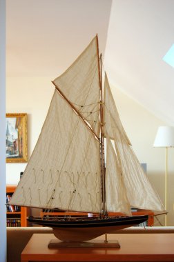 Model of ship with sails. clipart