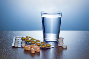 Pills, capsules and glass of water clipart