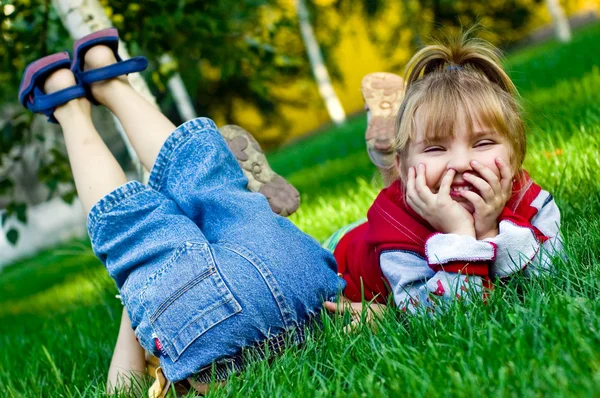 Забавные дети на зеленой траве — стоковое фото