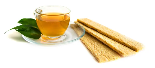 A mug of green tea and small loafs — Stock Photo, Image
