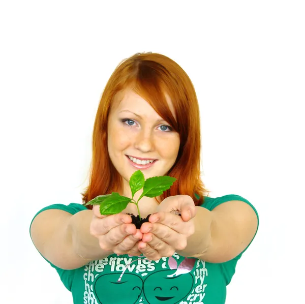 Beautiful young woman holding plant — Stock Photo, Image