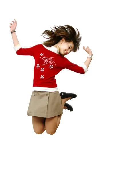 Flickan hoppar av glädje (skor i rörelse — Stockfoto