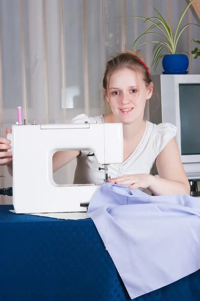 Stock image Beautiful girl sewing