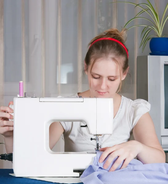 stock image Beautiful girl sewing
