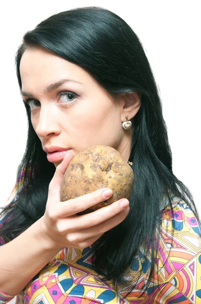 The girl with a crude potato in hands! — Stock Photo, Image