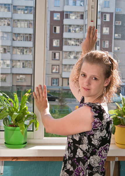 The girl closes a window