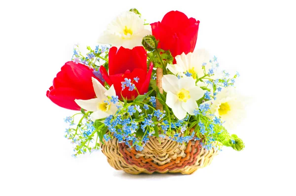 Bouquet of spring flowers in a wattled basket — Stock Photo, Image