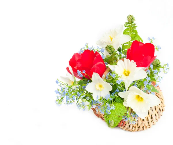 Bouquet of spring flowers in a wattled basket — Stock Photo, Image