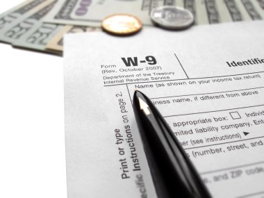 Filling the w9 Tax form by pen clipart