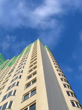 New colorful green building, blue sky clipart
