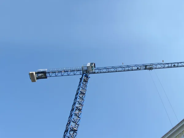 Vysoký jeřáb silueta na modré obloze, sunny — Stock fotografie