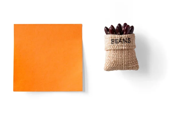 Sticky note and beans in a packet — Stock Photo, Image