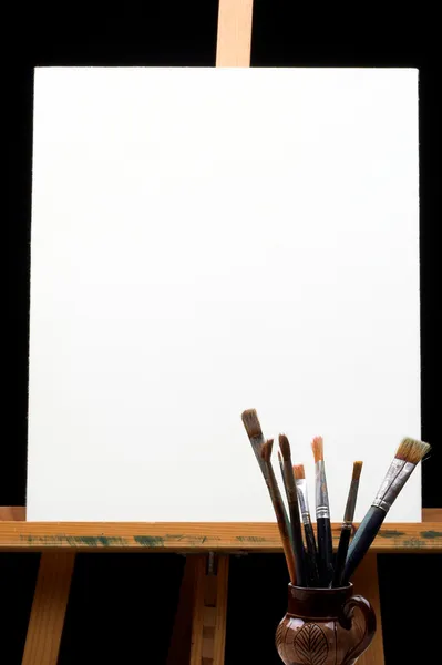Canvas,brushes and easel — Stock Photo, Image