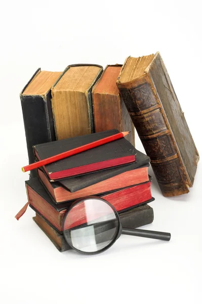 Old books and magnifier — Stock Photo, Image