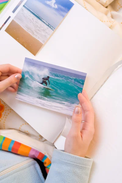 Sticking images to photo album Royalty Free Stock Images