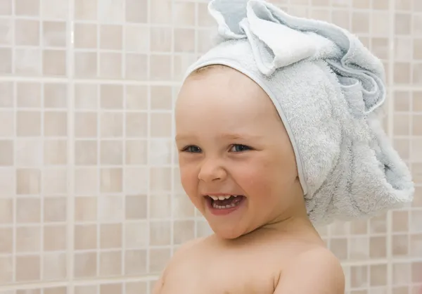Small smiling girl in bath with towel — Stock Photo, Image