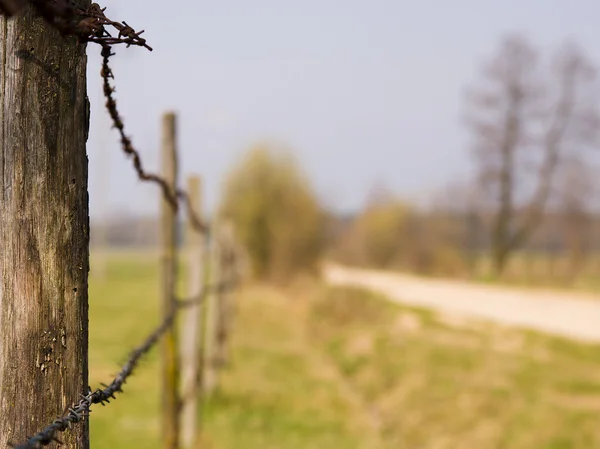 stock image Fence by the meadow in rural landscape