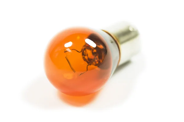 Isolated amber lightbulb — Stock Photo, Image