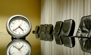 Clock in the empty board room clipart