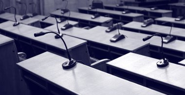 Microphones in empty conference hall clipart