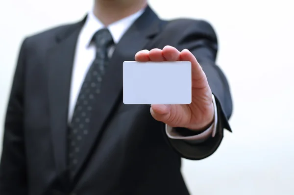 Businessman is holding business card in his hand — Stock Photo, Image